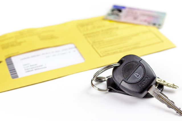 Autoschlüssel und Personalausweis liegen neben einem gelben Umschlag (verweist auf: Übermittlung von Fahrzeug- und Halterdaten durch das Kraftfahrt-Bundesamt (KBA))